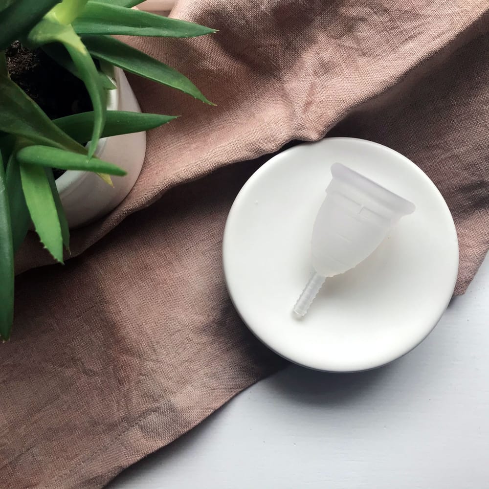 Menstrual cup on a ceramic dish